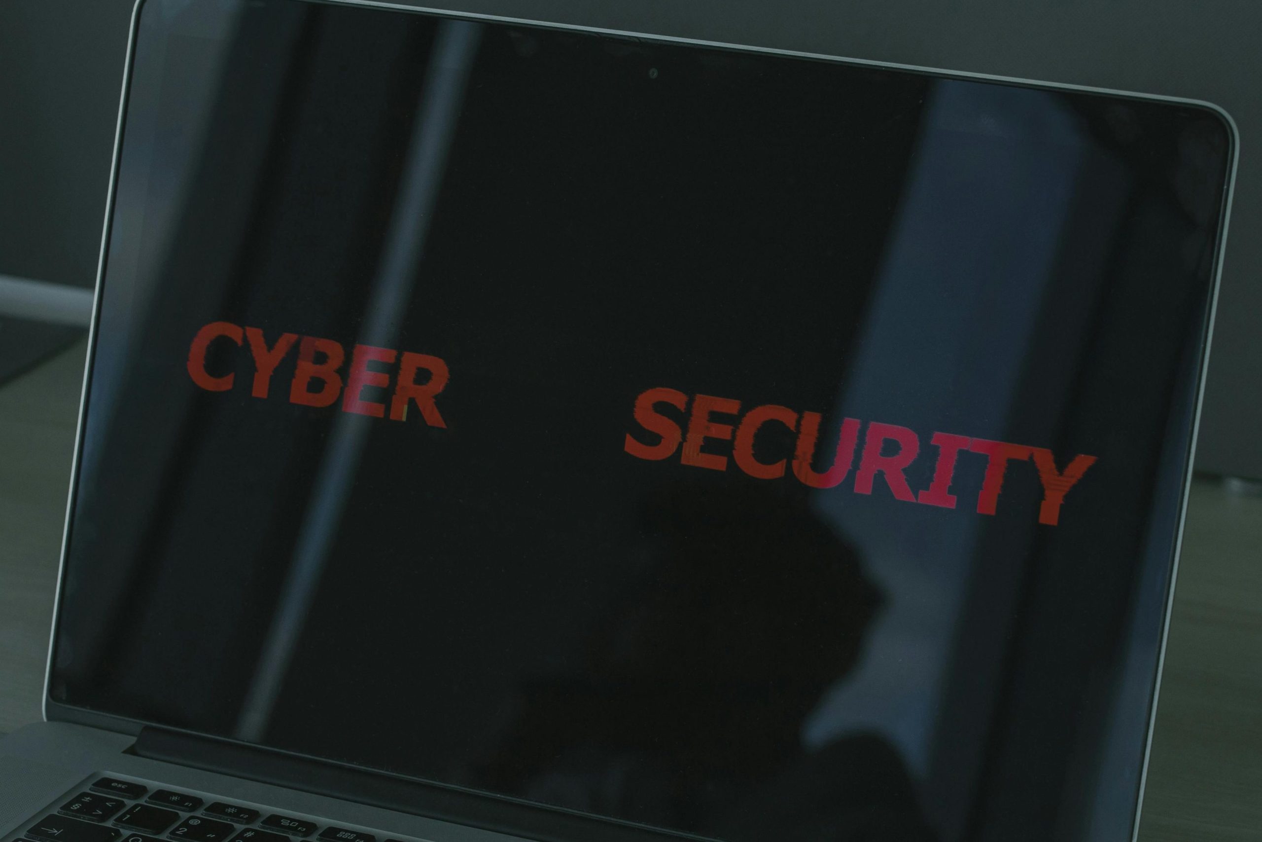 Close-up of a laptop displaying cybersecurity text, emphasizing digital security themes.